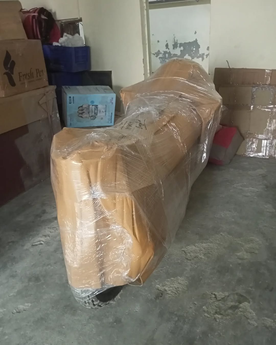 Two-wheeler packed with cardboard and stretch wrap